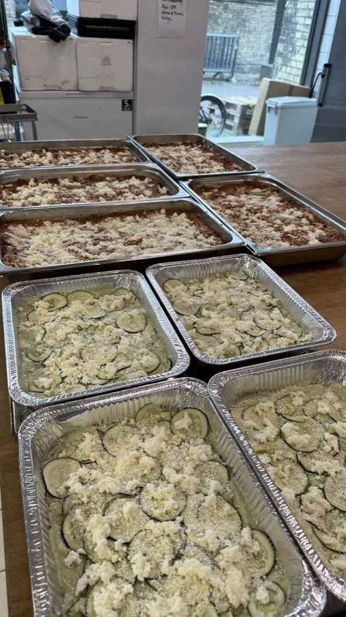Trays of fresh lasagne prepared for a large catering order