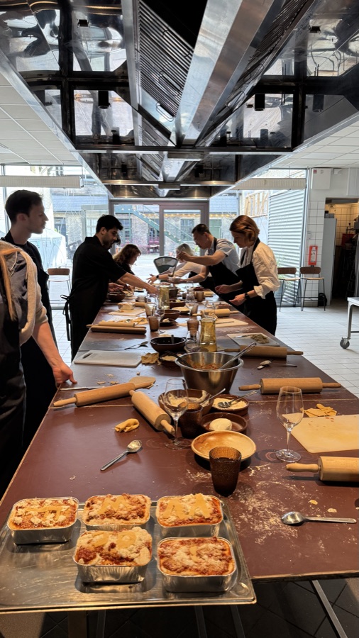 Team gathered around a long table for a Lasagne Hub event